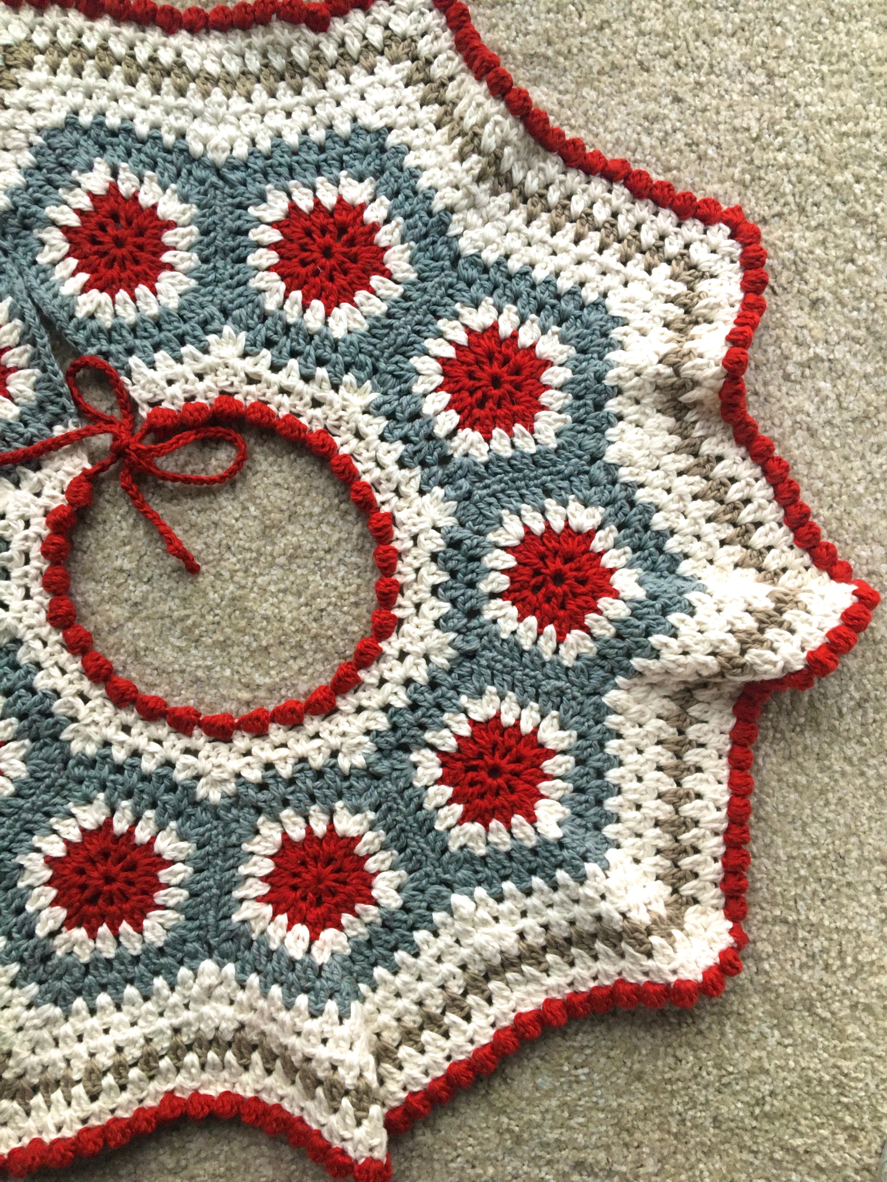 white, red, and brown crocheted tree skirt