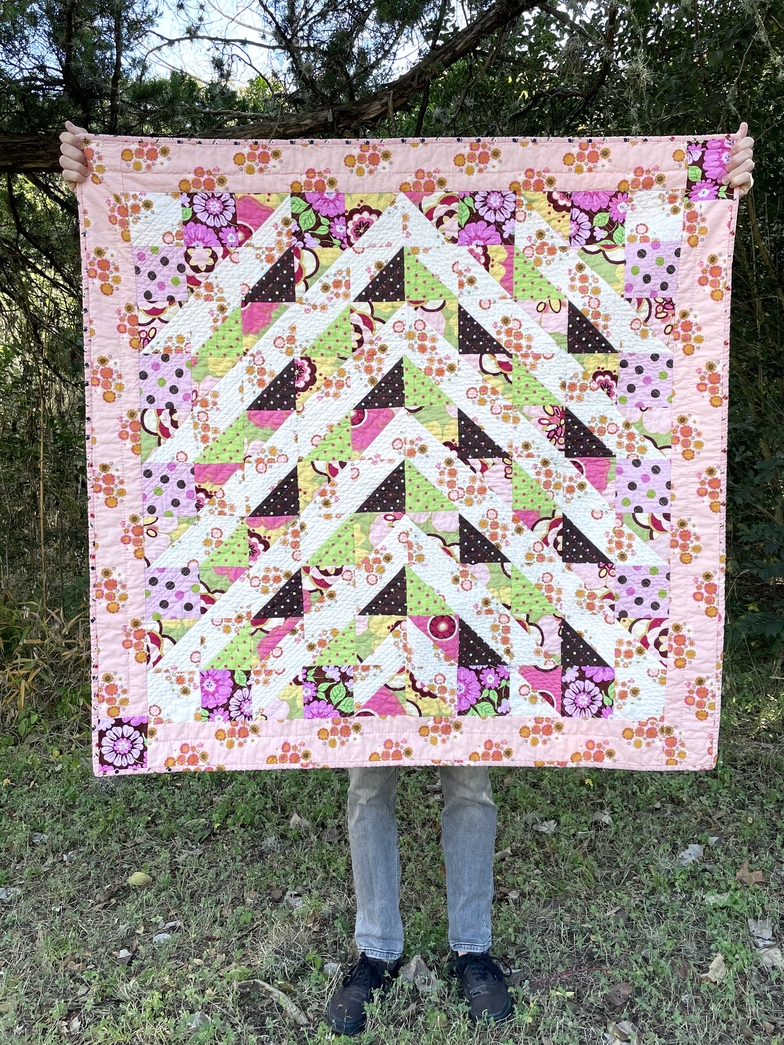 pink, brown, and green highly patterened quilt